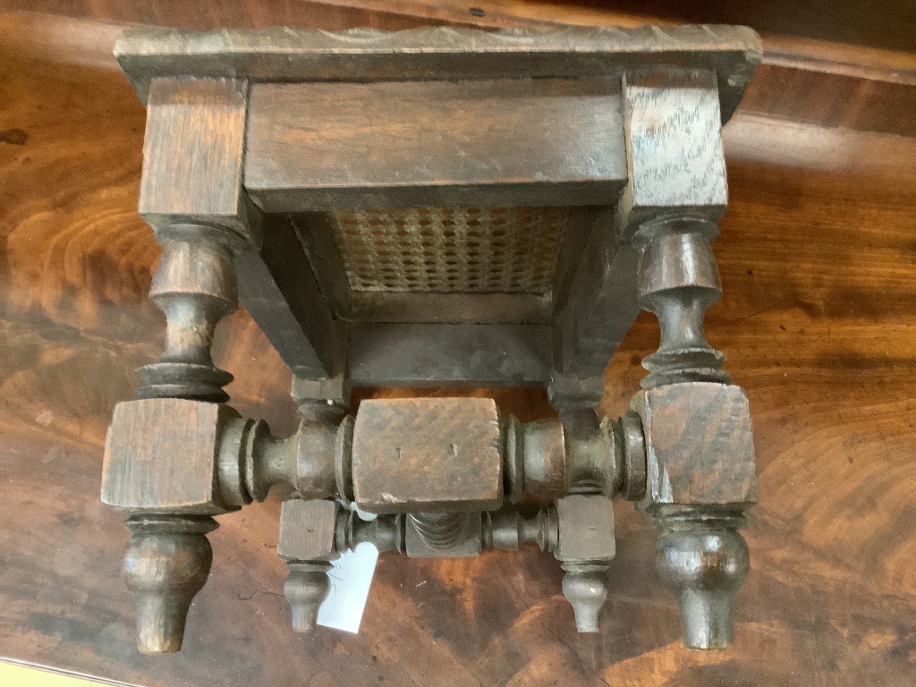 An early 20th century carved oak stool, width 29cm